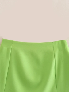 Detailed macro view of light green twill fabric and high-quality waist tailoring details