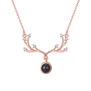 Rose gold reindeer antler necklace with blue projection stone and sparkling crystals