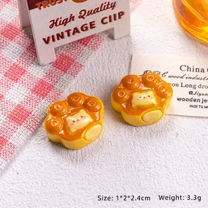 Close-up of cat paw resin charms for DIY crafts with 1x2x2.4cm size details shown