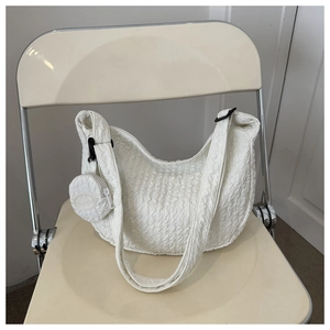Detail of white pleated canvas shoulder bag with matching round fashion coin purse