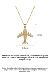 Detailed view of gold airplane pendant with pave zircons and adjustable steel chain