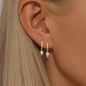Macro view of S925 sterling silver golden bee drop earrings with sparkling zircon stones
