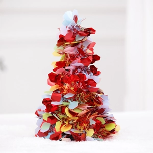 Close-up of red foil tabletop Christmas tree with sparkling colorful star sequins