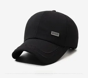 Detailed view of herringbone fabric and silver sport metal plate on baseball cap side