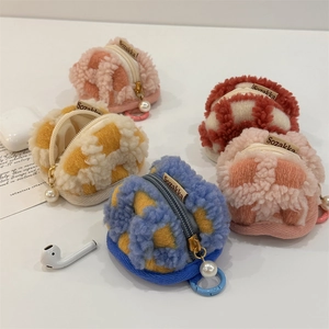 Macro shot of colorful waffle plush earphone pouches with elegant pearl zipper charms