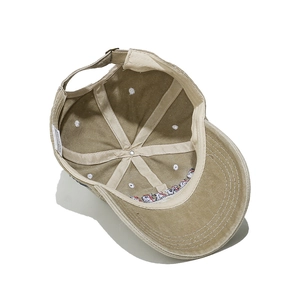 Internal structure of tan baseball cap with adjustable metal buckle and inner sweatband