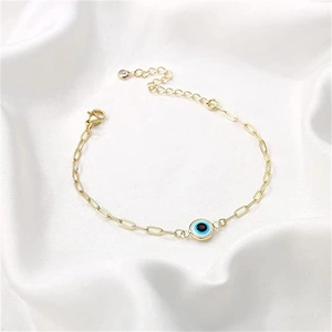 Detail of gold evil eye paperclip bracelet with lobster clasp and extension chain