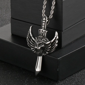 Detailed close-up of gothic lion head and wings pendant in vintage steel finish