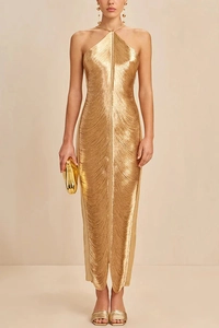 Front view of a shiny gold tassel halter maxi dress for women on a beige background
