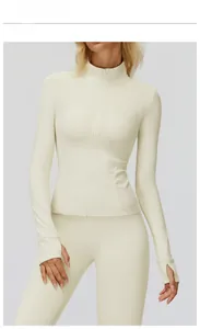 Detail of creamy apricot slim-fit sports jacket with thumbhole cuffs and high stand collar