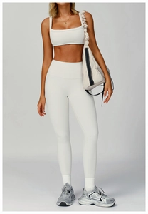 Close-up of ribbed texture on white yoga set featuring high-waist leggings and crop top
