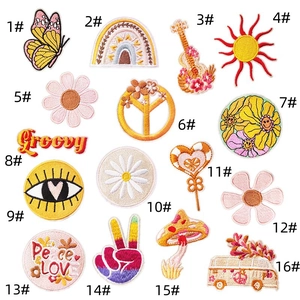 Macro detail of 16 boho embroidery patches featuring groovy icons and hippie style designs