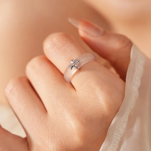 Macro view of translucent chalcedony ring featuring a vintage silver cross embellishment