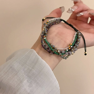 Detail of multi-layer beaded bracelet with adjustable pull cord and colorful glass beads
