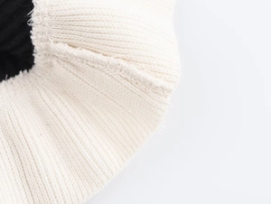 Detailed macro view of cream rib-knit fabric with premium black thickened lining and seams