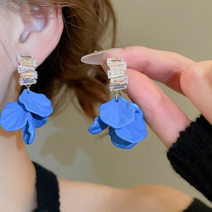 Detail of blue acrylic petal tassel earrings with sparkling clear cubic zirconia accents