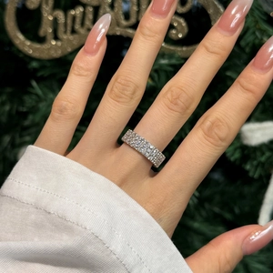 Close-up of sparkling S925 sterling silver wide band ring with zircons on finger