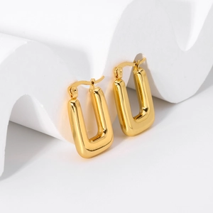 Macro shot of 18K gold plated square hoop earrings on a minimalist white display