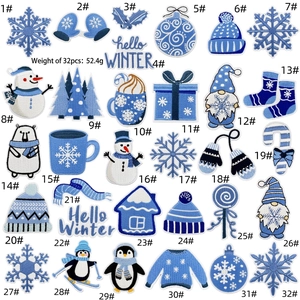 Detailed grid of 32 blue winter embroidery patches featuring snowmen and penguins