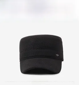 Detail of black winter military flat top cap with side diamond-shaped metal badge