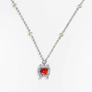 Detailed macro view of heart pendant with red center stone and multicolor zircon accents