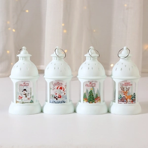 Set of four white Christmas LED lanterns with festive scenes for tabletop decoration
