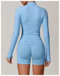 Rear view of slim fit seamless yoga jacket and shorts in light blue sports fabric