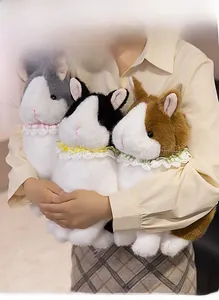 Detailed view of plush rabbit toys in gray, black, and brown with lace collars