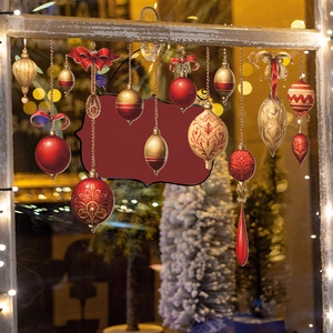 Christmas window stickers with red and gold baubles on warm holiday background