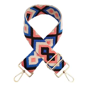 Close-up of pink and blue geometric ethnic embroidery wide strap with gold hardware