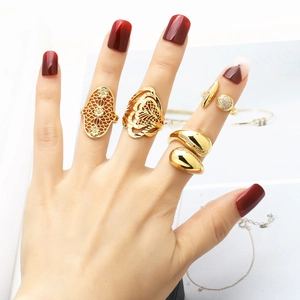 Gold plated irregular rings with zircons on model hand in a minimalist setting