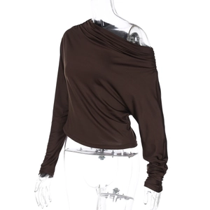 Détail des plis élégants et du tissu marron brillant du haut à épaules dénudées