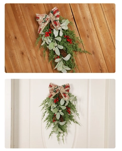 Detail of Christmas wall hanging with pine cones, red berries and Merry Christmas bow