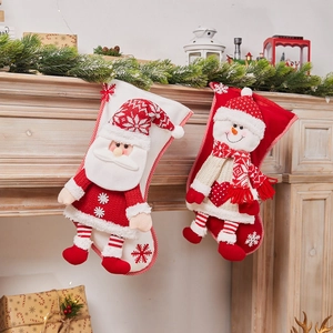Christmas stockings with Santa and Snowman hanging on a festive decorated fireplace