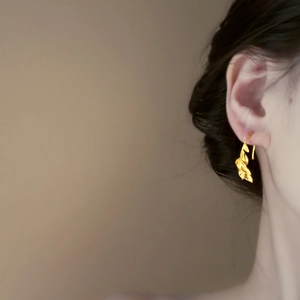 18k gold plated leaf drop earrings shown on model with elegant vintage gold texture