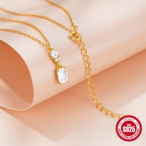 S925 sterling silver gold necklace with emerald-cut zirconia pendant on pink background