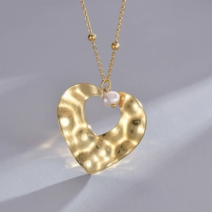 14K gold plated stainless steel necklace with heart pendant and pearl accent on grey background