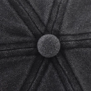 Macro shot of the black corduroy cap crown showing stitching detail and fabric texture