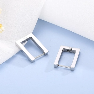 Macro shot of silver minimalist rectangular geometric hoop earrings with polished finish