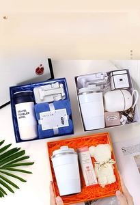 Three premium business gift sets featuring travel mugs, bear towels, and hand creams