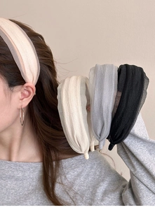 Detail of elegant chiffon wide headband in soft pink, cream, grey and black colors