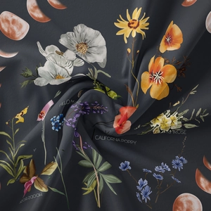Close-up of bohemian moon phase tapestry fabric with vintage floral botanical patterns