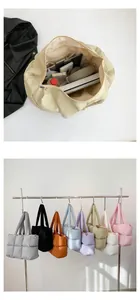 Detailed interior of a spacious quilted puffer tote bag with multiple color options