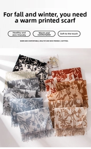 Detailed view of floral print faux cashmere scarves with fringe edges in multiple colors