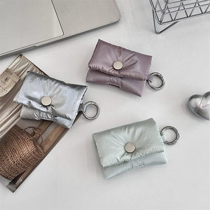 Metallic quilted earbud pouch in silver, purple, and green with a metal carabiner