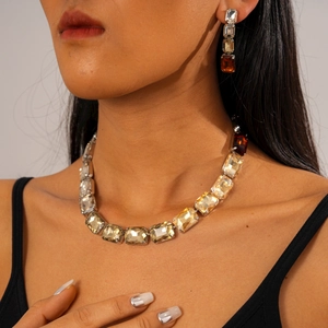 Macro view of geometric crystal necklace set with rectangular amber and champagne stones