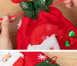 Detail of red felt Christmas apple gift bag with 3D Santa Claus pattern and drawstring closure