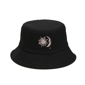 Minimalist black cotton bucket hat featuring embroidered sun and moon celestial graphics