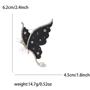Detailed view of enamel butterfly brooch with dimensions 6.2cm height and 4.5cm width