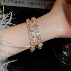 Elegant heart-shaped tennis bracelet with pink and white gems in gold plating